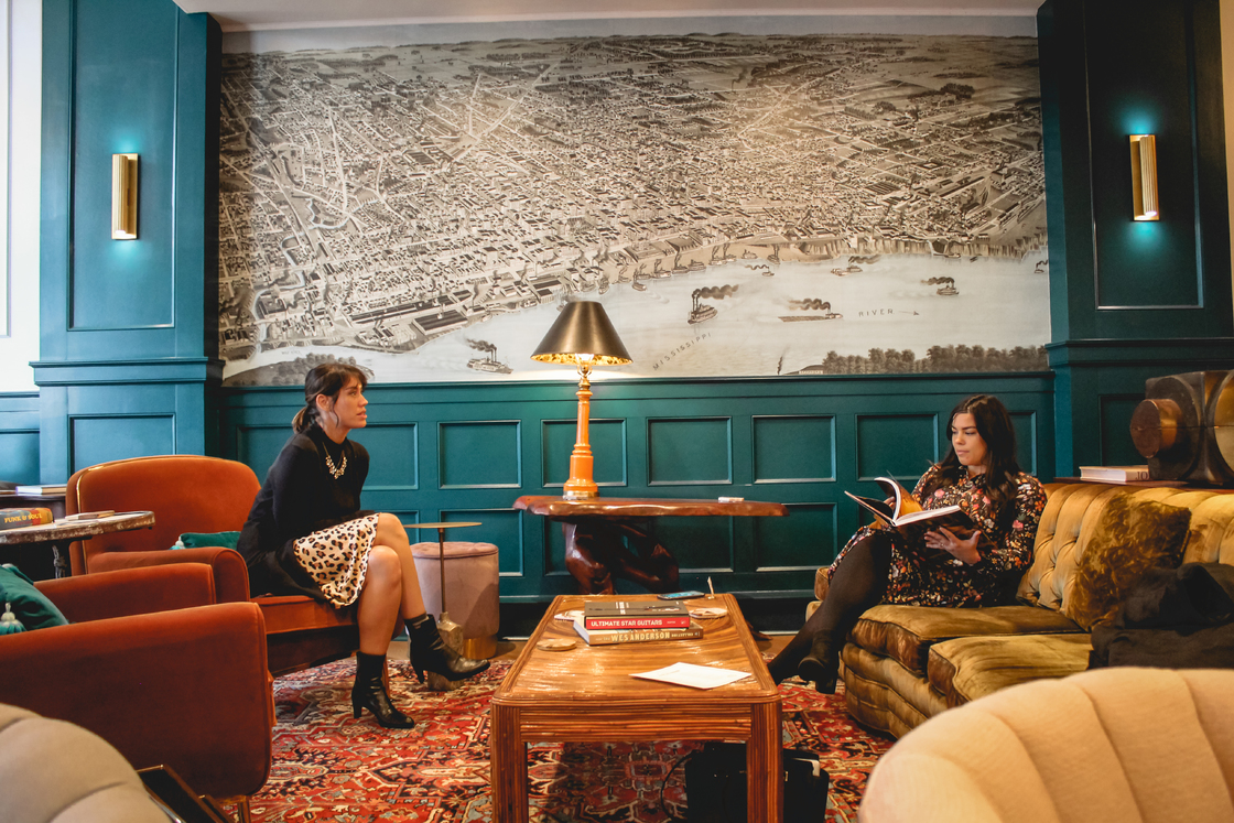 Two women sit in the lobby of the Arrive Hotel | Holly Whitfield