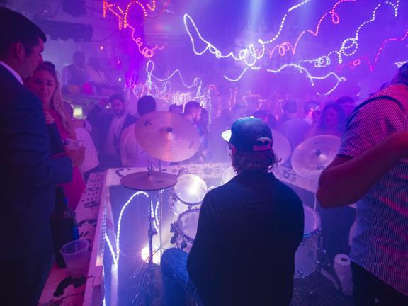 man plays drum set on dance floor in Paula raifords disco