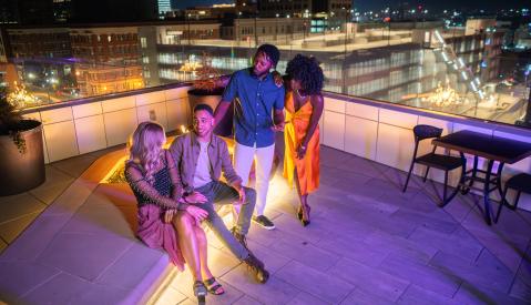friends gathering around rooftop fire pit
