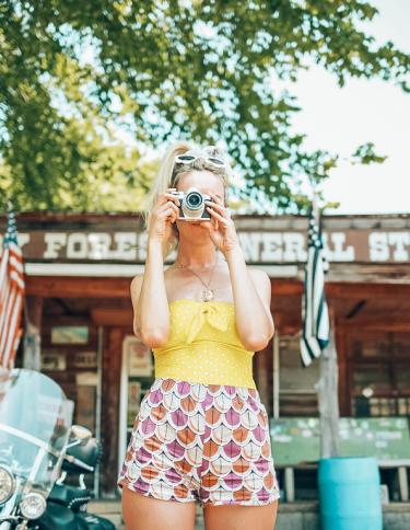 Girl snapping a photo in front of Shelby Forest General Store in Millington near Memphis | Oui We Girl
