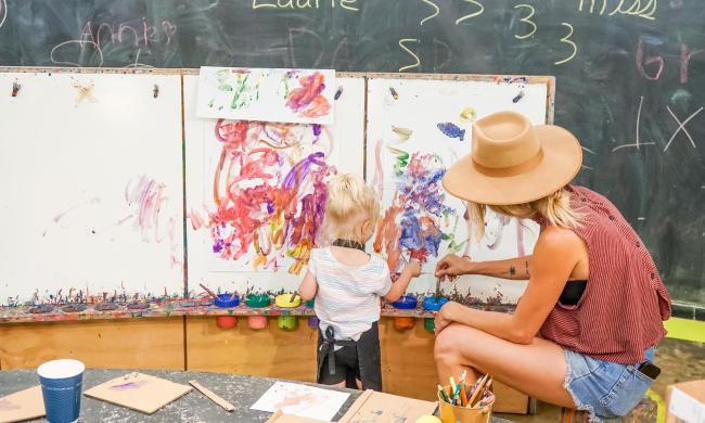 A mom and daughter painting on canvas at The Art Project.