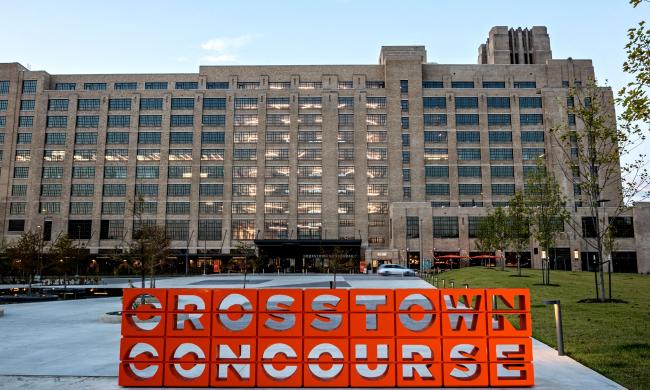 Crosstown Concourse exterior with an orange Crosstown Concourse sign out front.