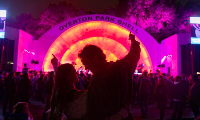 A couple stands together in front of Memphis' Overton Park Shell during a concert