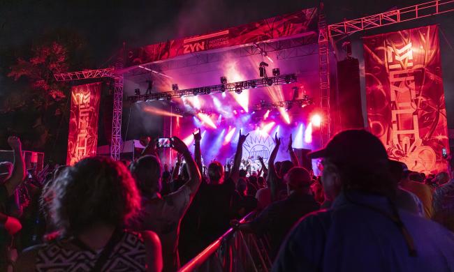 viewpoint from fan at mempho music festival looking around stage lit up in pink and red