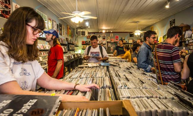Shoppers browsing the records and merch inside Goner Records.
