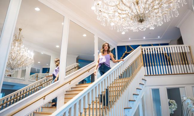 woman stands on stairs in guest house hotel