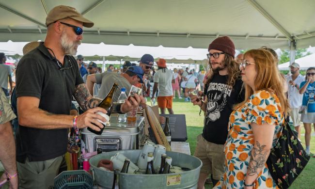 brewery rep pours samples for Brewfest patrons