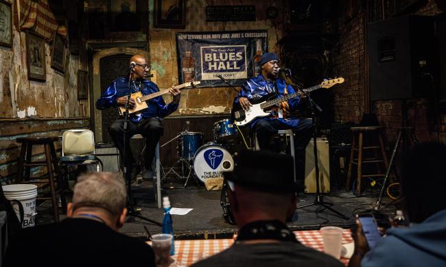 Two musicians perform on stage at Rum Boogie's Blues Hall in sequin blue blazers during the International Blues Challenge