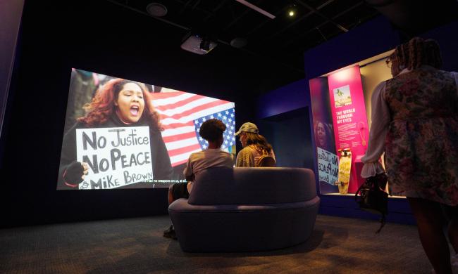 women watch protest film at National Civil Rights Museum Legacy Experience