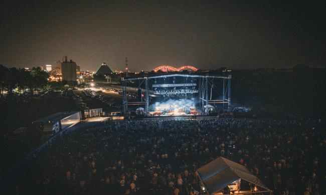 aerial view of Grind City Amp stage during Alabama Shakes Show with Memphis skyline in background featuring the Bass Pro Pyramid and lit up M Bridge