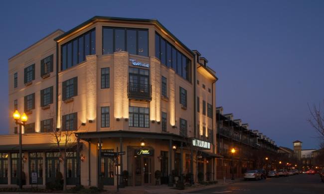 The exterior of the River Inn Hotel at night in Harbor Town.