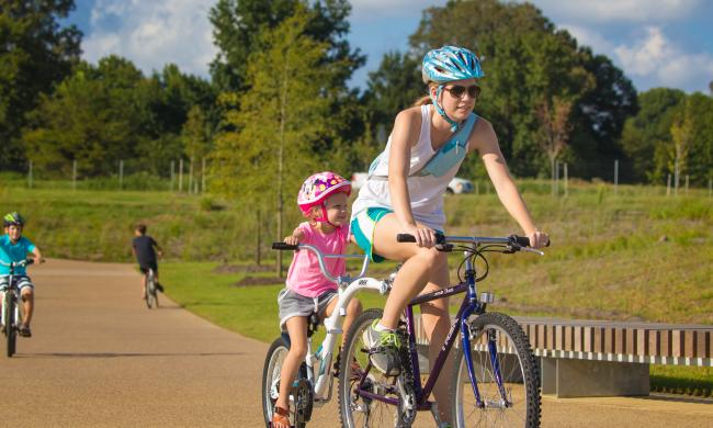 A mother and daughter cycling at Shelby Farms Park.