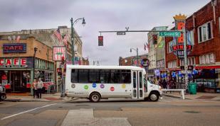 Blues City Tours bus drives by Beale Street
